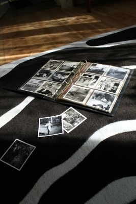 A photo album laid out on the floor