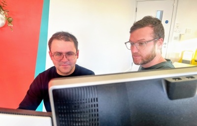Two software engineers looking at a computer screen together