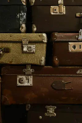 A stack of vintage and old suitcases